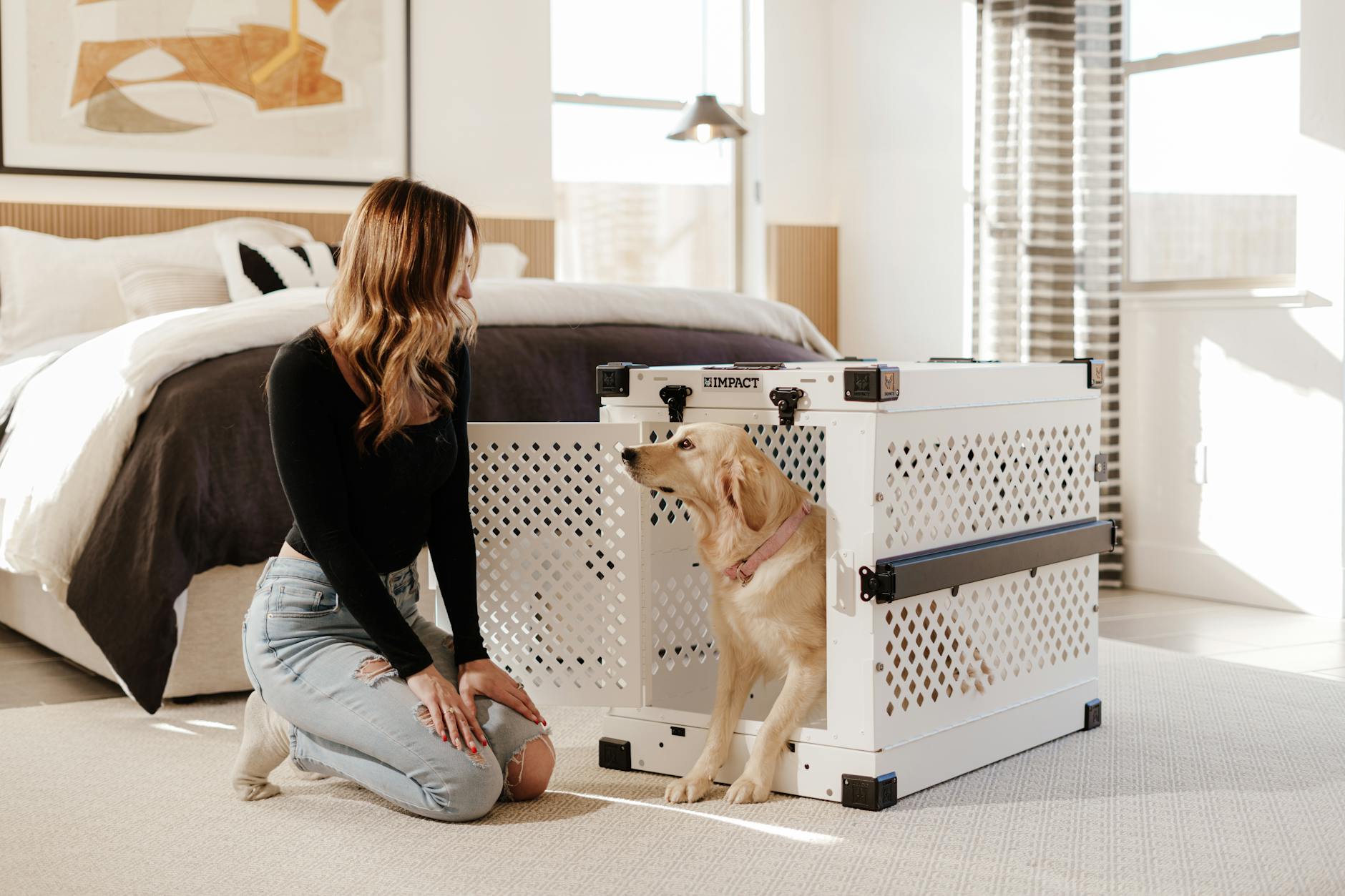 woman and golden retriever in modern bedroom setting